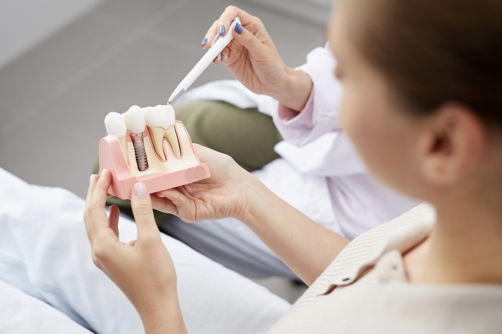dentist showing their patient a dental implant